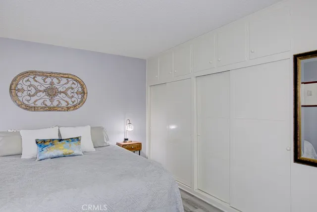 a bed room with a bed and a painting on the wall