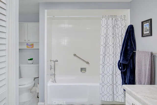 a bathroom with a shower a toilet and a bathtub