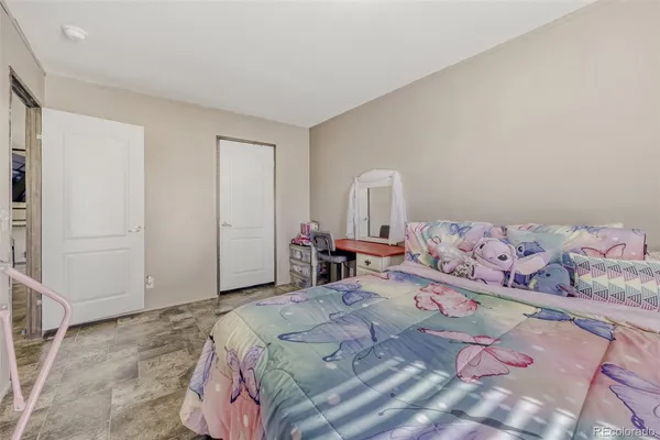 a bedroom with a bed and chair