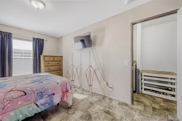 a bedroom with a bed and a window