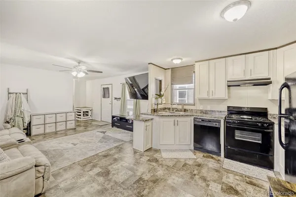 a kitchen with refrigerator and cabinets