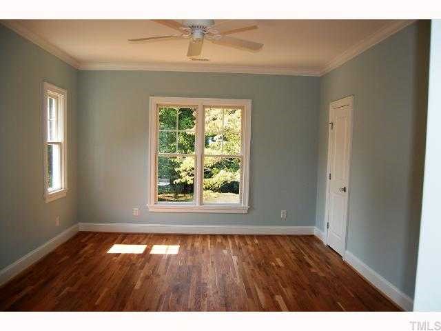 2113 Noble Road Raleigh, NC 27608 - Photo 7 of 11 a view of an empty room with wooden floor and a window