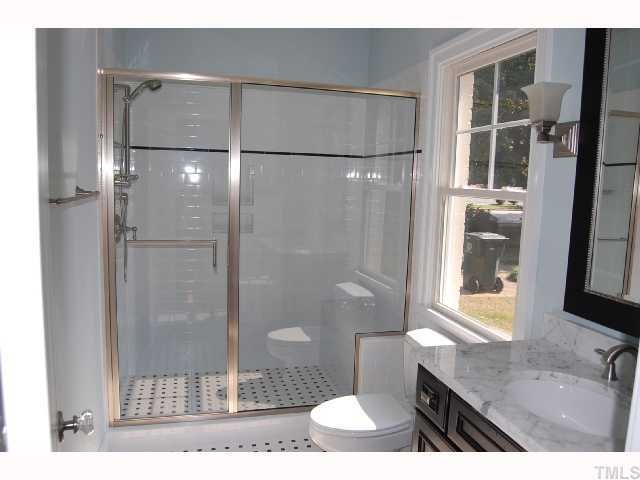 2113 Noble Road Raleigh, NC 27608 - Photo 9 of 11 a bathroom with a sink and a mirror