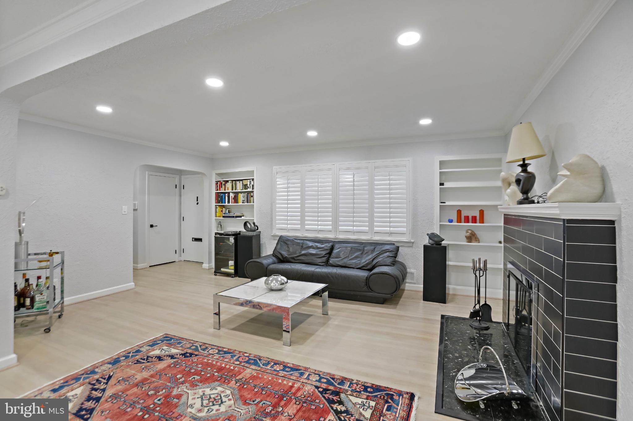 3906 Ridge Road Annandale, VA 22003 - Photo 6 of 34 a living room with furniture a rug and a fireplace
