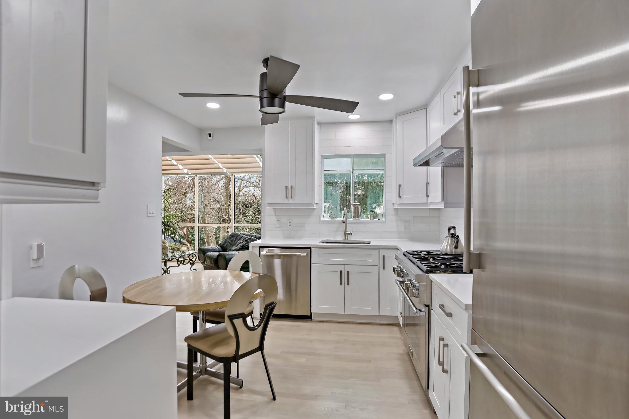 3906 Ridge Road Annandale, VA 22003 - Photo 9 of 34 a kitchen with a table chairs stove and cabinets