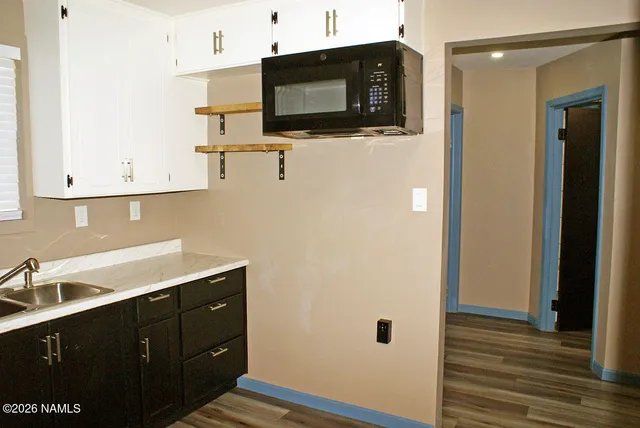 a kitchen with a sink and cabinets