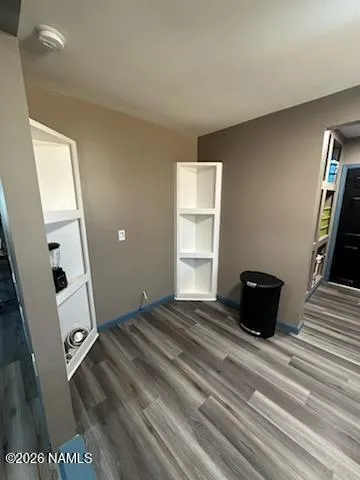 a view of a livingroom with wooden floor and a window