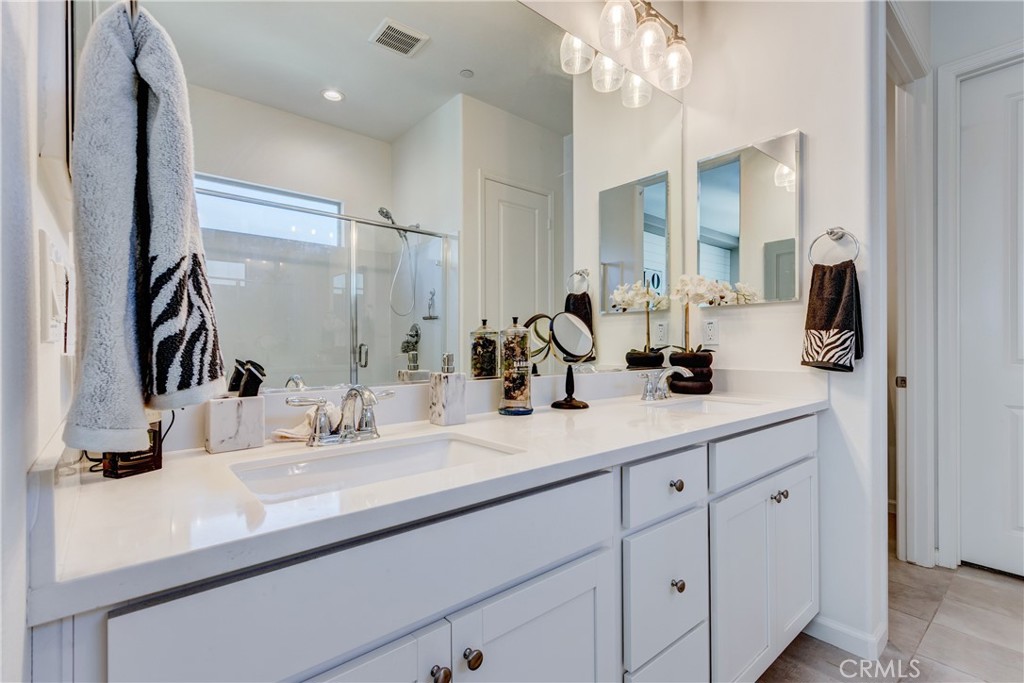 11137 Briar Rose Court Corona, CA 92883 - Photo 31 of 75 a bathroom with a sink double vanity and a mirror