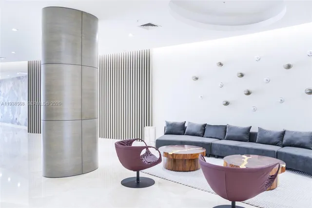 a living room with furniture a rug and a potted plant