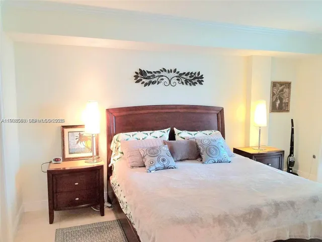 a bedroom with a bed and a night stand