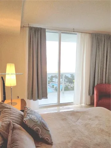 a bedroom with a bed and a lamp with window