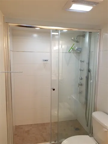 a bathroom with a shower and toilet