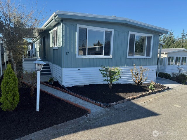 1415 84th Street Southeast, Unit 17 Everett, WA 98208 - Photo 1 of 32 a front view of a house with garden