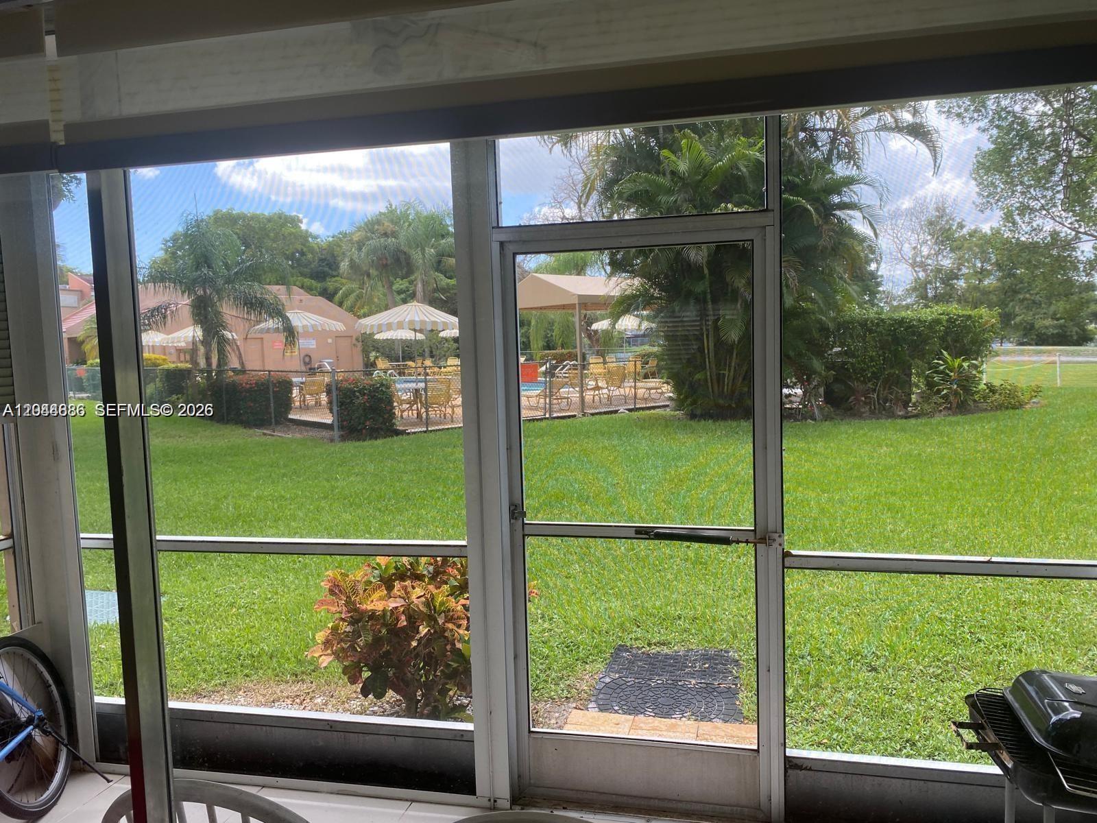 8838 West McNab Road, Unit 104 Tamarac, FL 33321 - Photo 16 of 23 a view of a garden from a window
