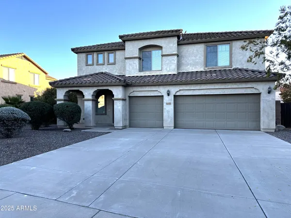 a front view of a house with a yard and garage