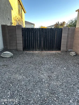 a view of a backyard with wooden fence