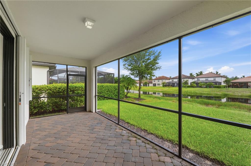 4374 Bismark Way Naples, FL 34119 - Photo 30 of 49 Screened patio featuring paver flooring, a white ceiling, and an overhead light fixture