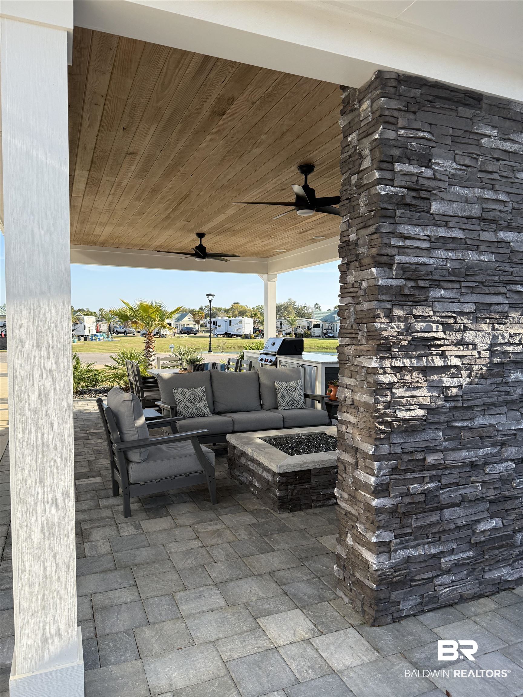 12377 Gateway Drive Elberta, AL 36530 - Photo 18 of 64 View of patio with ceiling fan, a residential view, an outdoor living space with a fire pit, and area for grilling