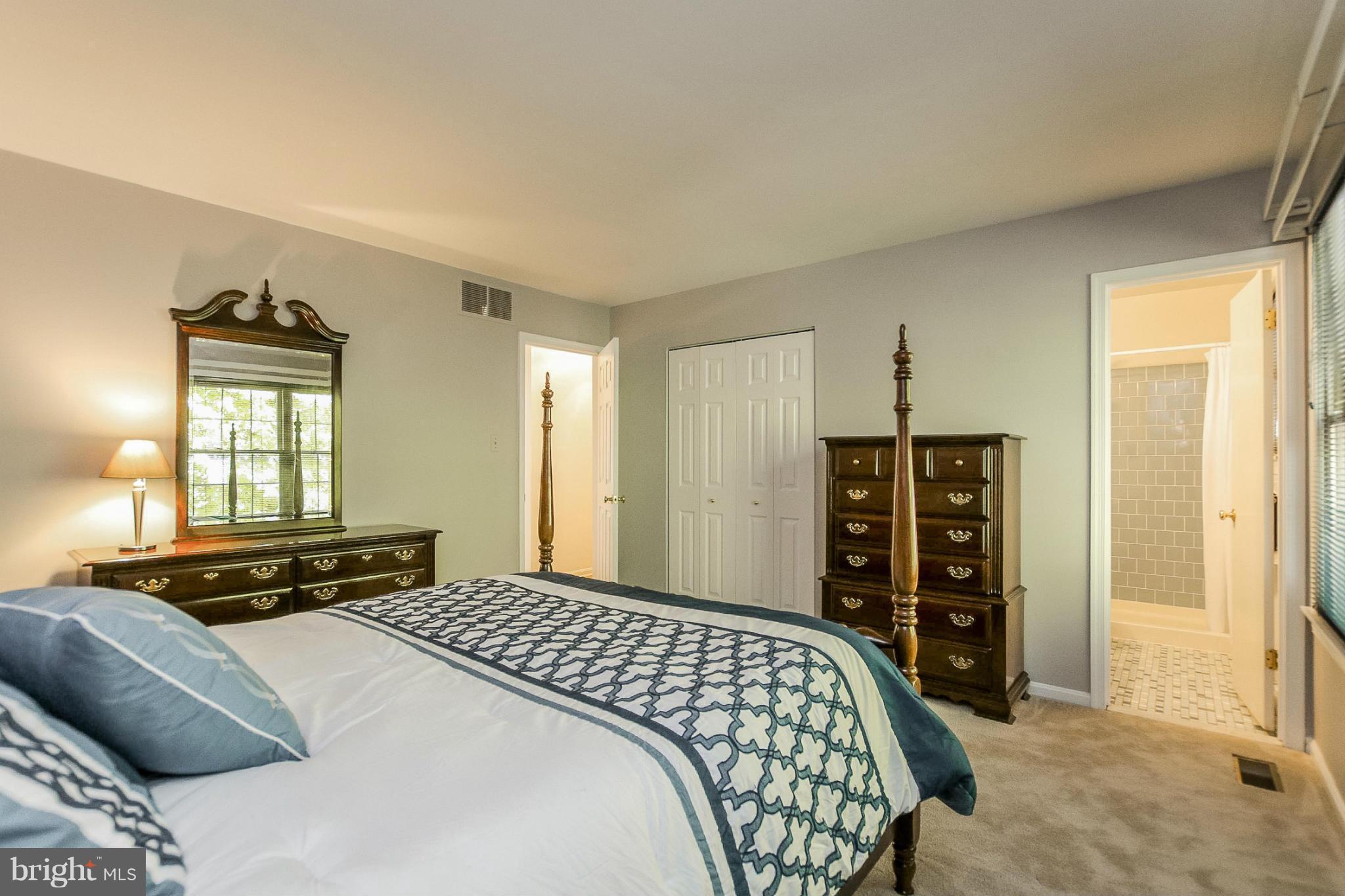 9338 Oak White Road Baltimore, MD 21236 - Photo 12 of 27 a bedroom with a bed and a window