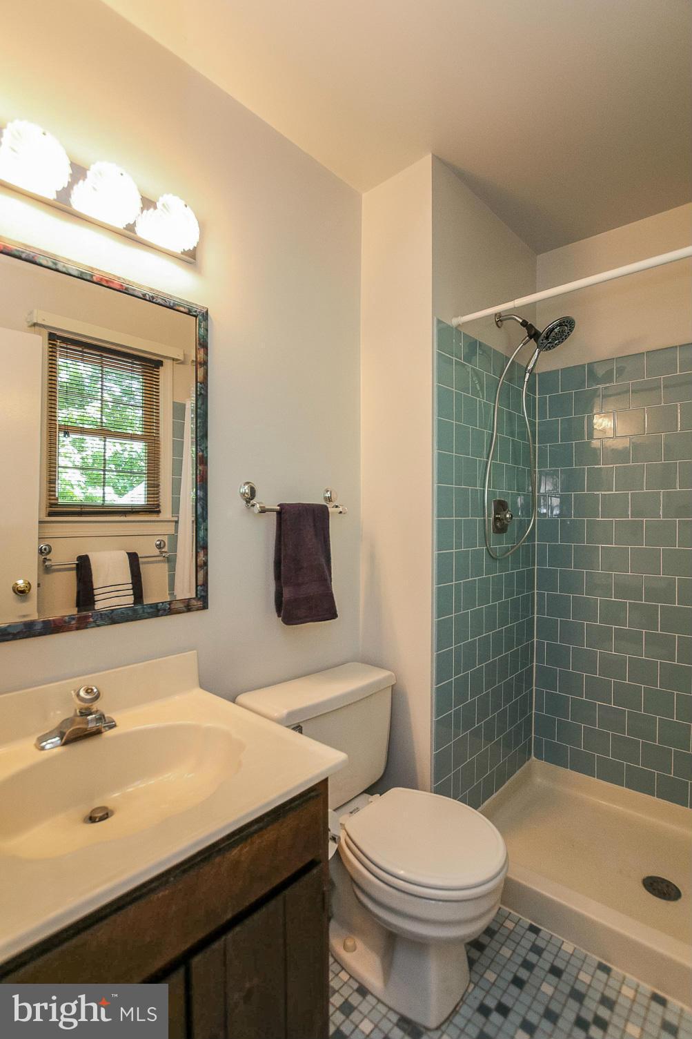 9338 Oak White Road Baltimore, MD 21236 - Photo 14 of 27 a bathroom with a sink toilet and shower