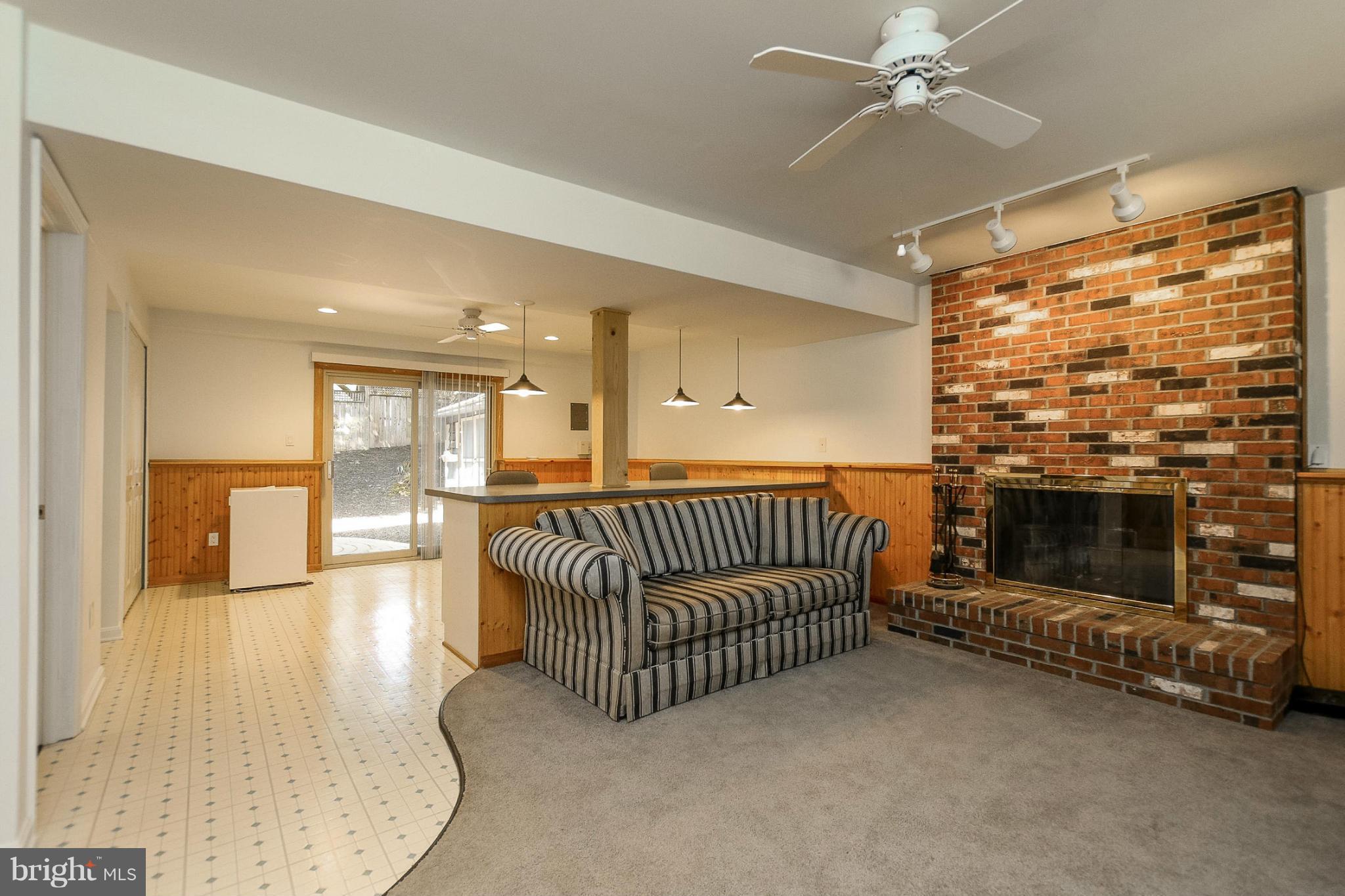 9338 Oak White Road Baltimore, MD 21236 - Photo 17 of 27 a living room with a couch and a fireplace