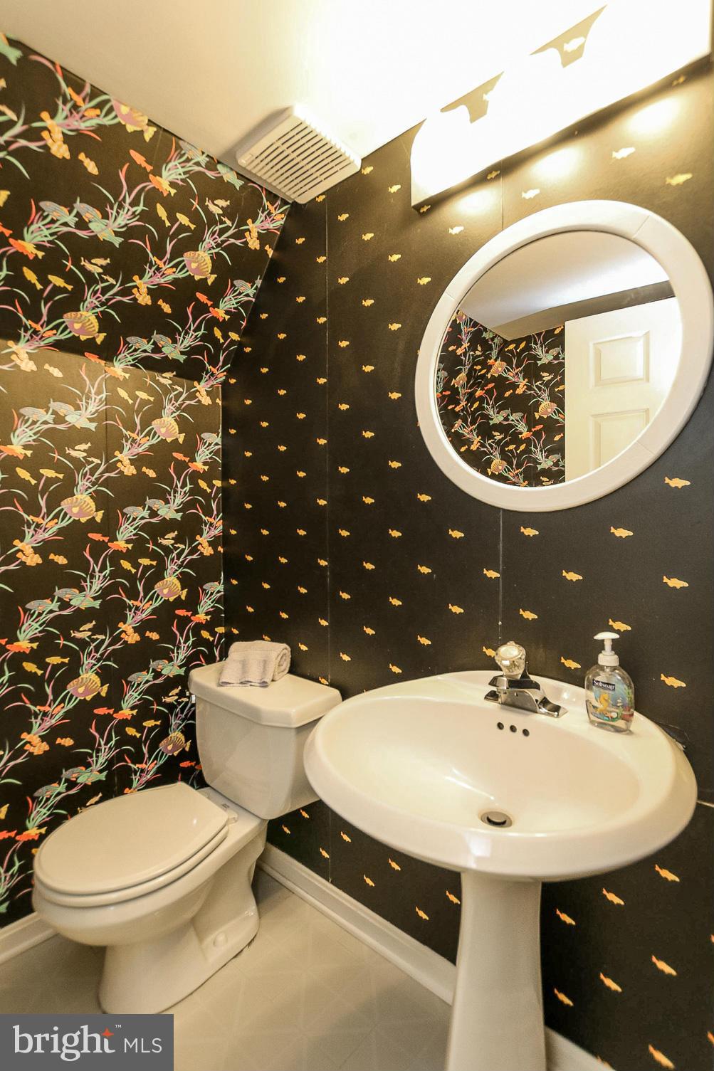 9338 Oak White Road Baltimore, MD 21236 - Photo 21 of 27 a bathroom with a sink and mirror