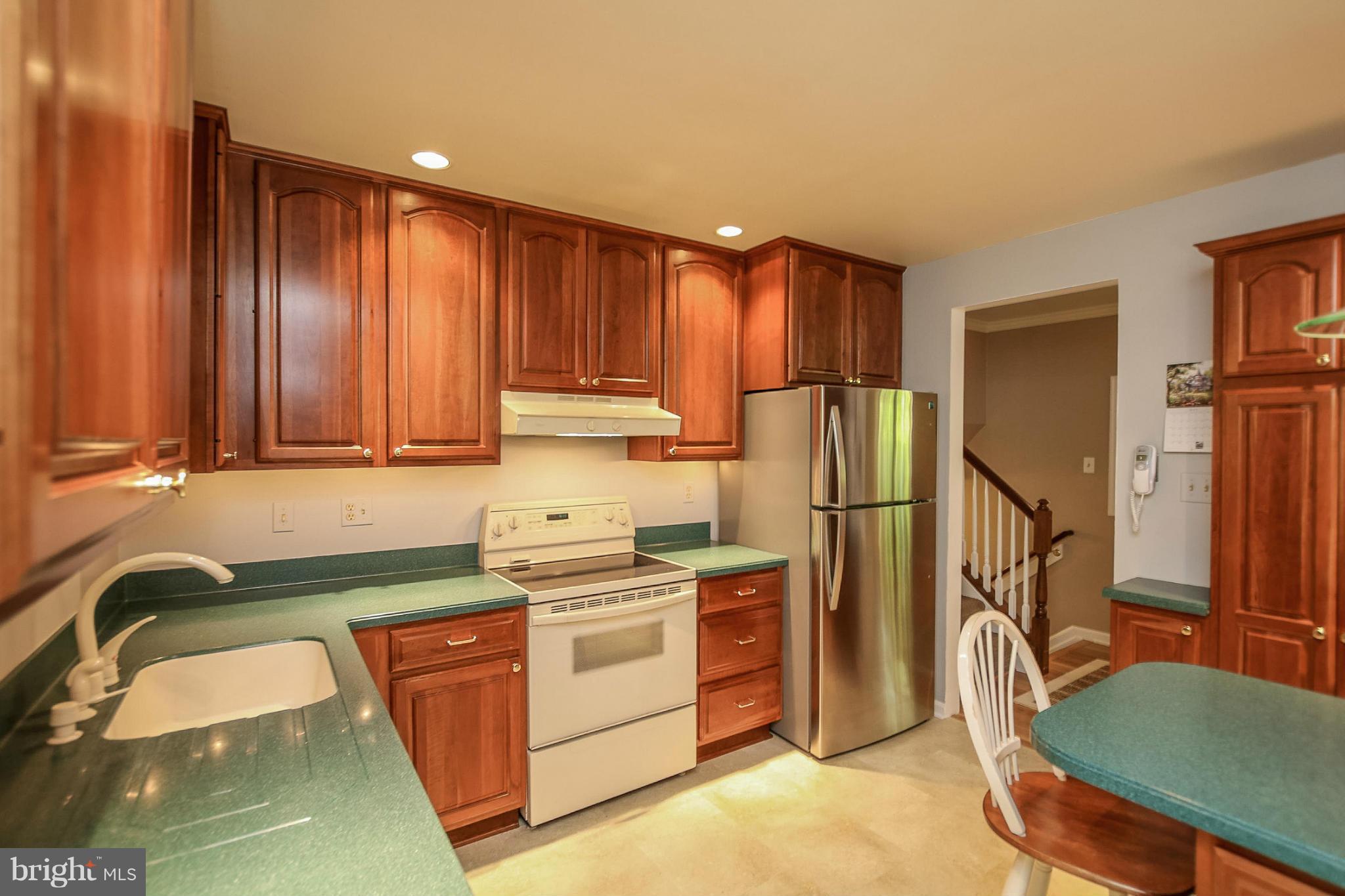 9338 Oak White Road Baltimore, MD 21236 - Photo 6 of 27 a kitchen with stainless steel appliances granite countertop a refrigerator sink and cabinets