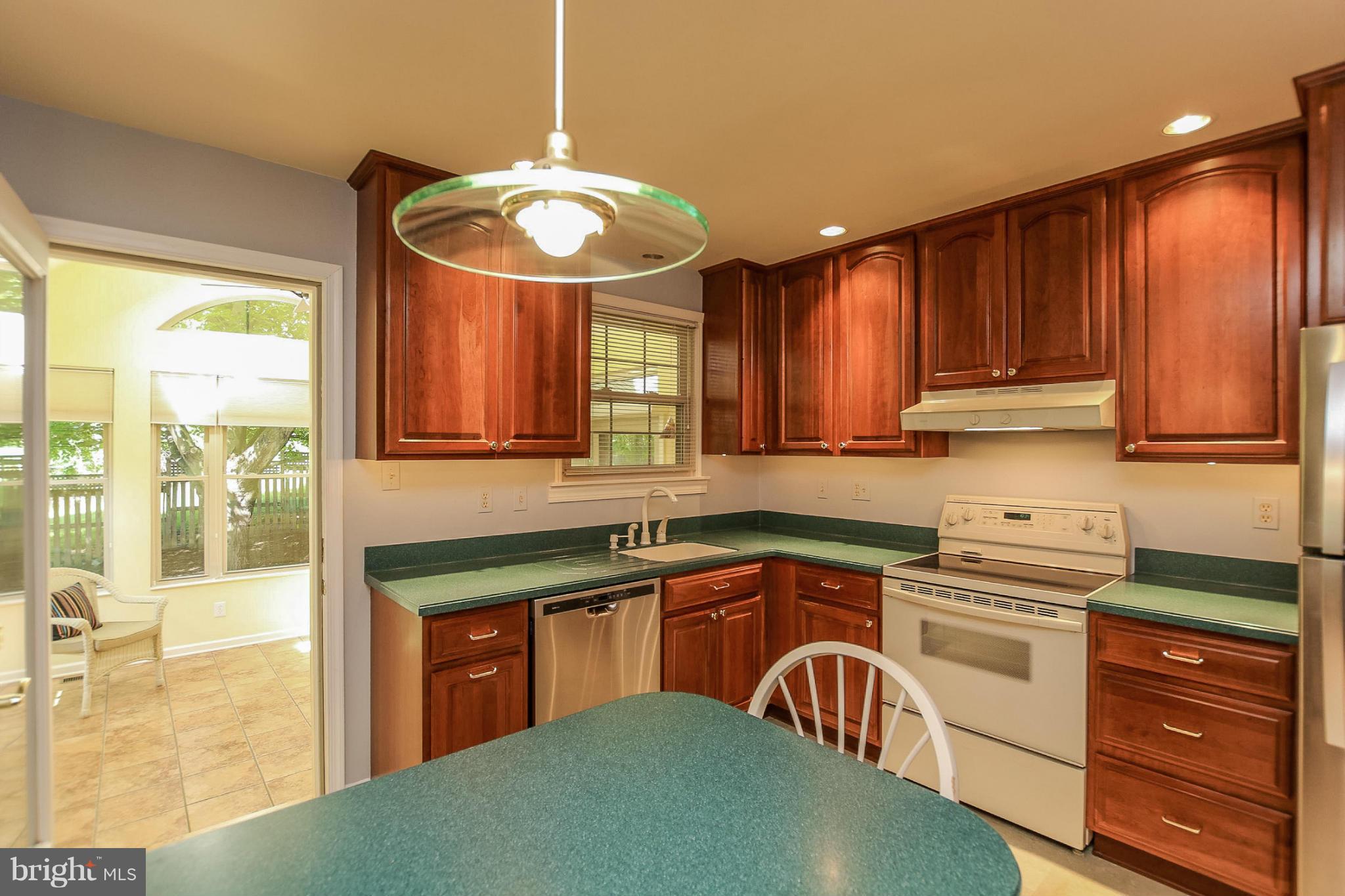 9338 Oak White Road Baltimore, MD 21236 - Photo 8 of 27 a kitchen with a stove a sink and a refrigerator