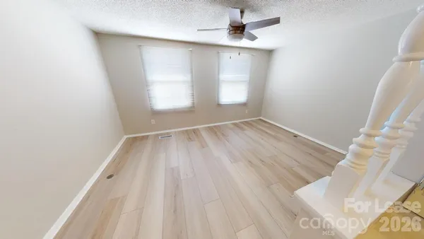 a view of a room with wooden floor