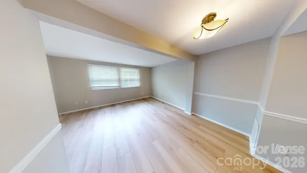 a view of a living room with wooden floor