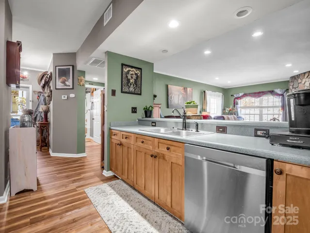 a kitchen with stainless steel appliances granite countertop a sink and cabinets