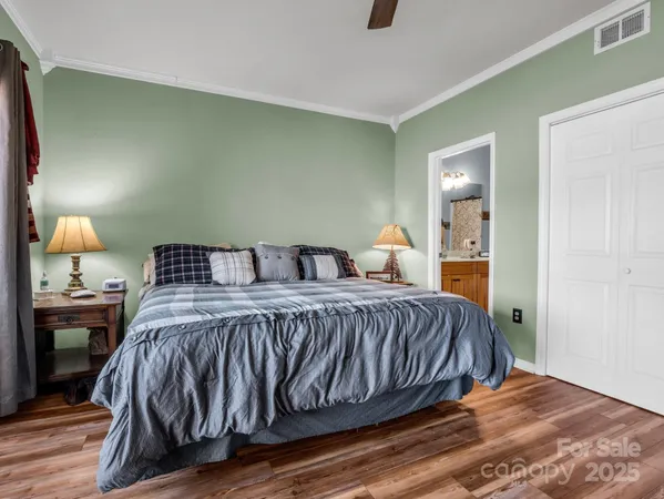 a bedroom with a bed and wooden floor