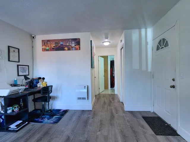 a view of a workspace with furniture and wooden floor