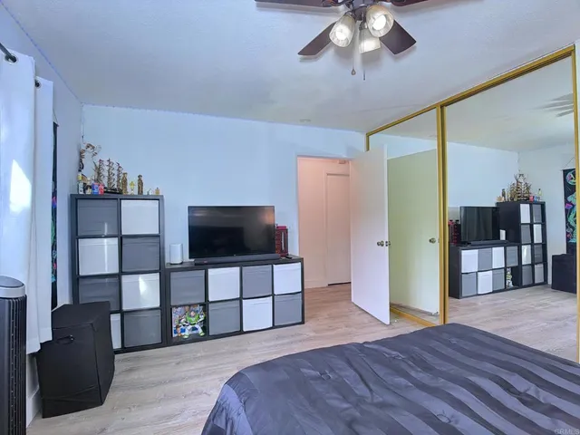 a bedroom with furniture and a flat screen tv