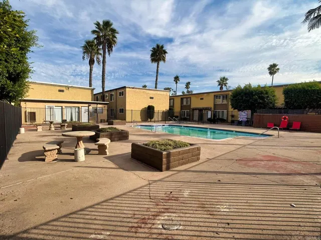 a swimming pool with outdoor seating