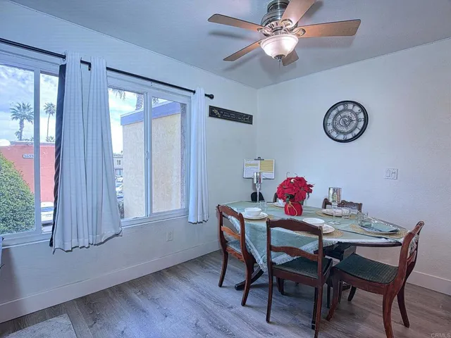 a dining room with furniture and a window