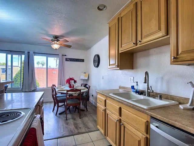 a kitchen with a dining table chairs and white appliances