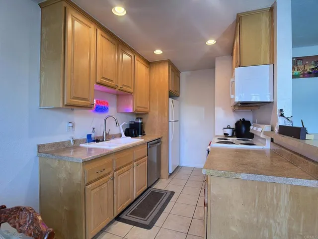 a kitchen that has a sink and a stove in it