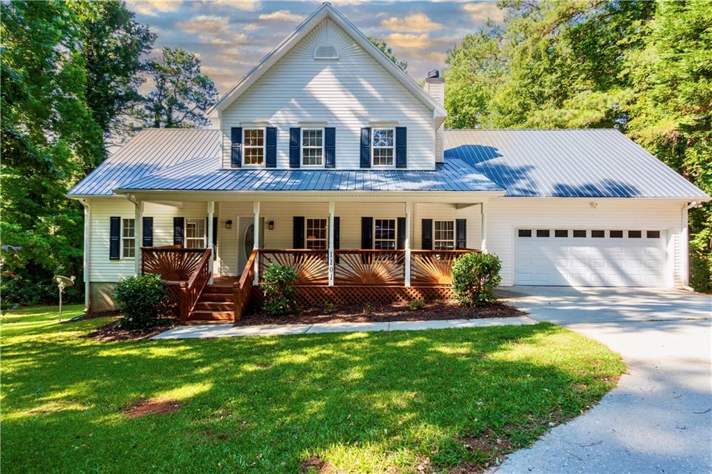 a front view of a house with a yard and outdoor seating