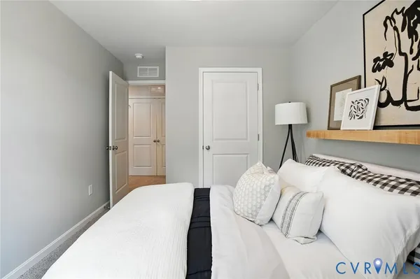 a bedroom with a bed and a lamp