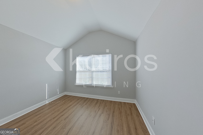 228 Western Red Cedar Drive Springfield, GA 31329 - Photo 11 of 27 an empty room with wooden floor and windows