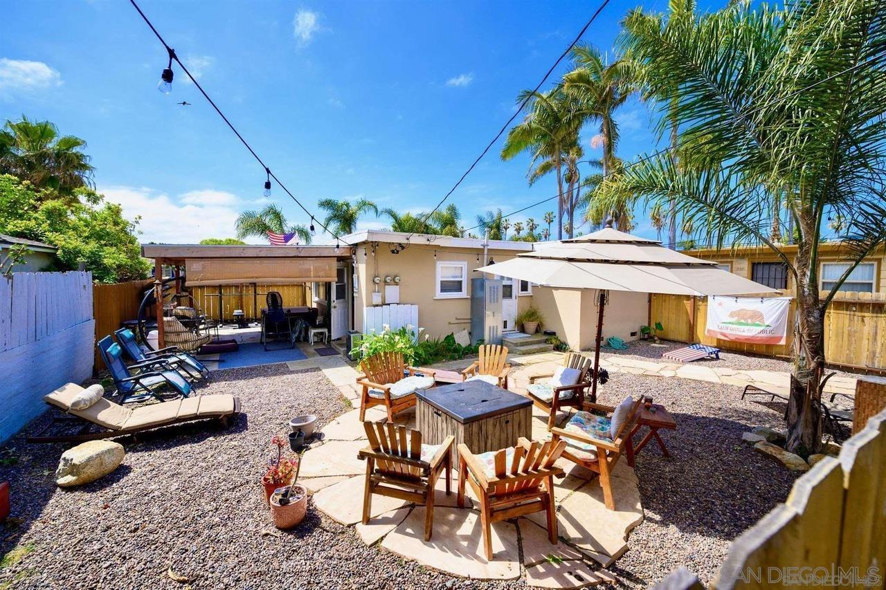 934 Reed Avenue San Diego, CA 92109 - Photo 12 of 39 a view of a patio with table and chairs under an umbrella