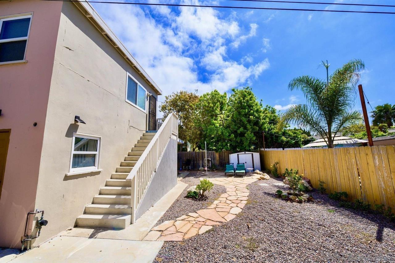 934 Reed Avenue San Diego, CA 92109 - Photo 17 of 39 a view of a house with wooden stairs and a lake view
