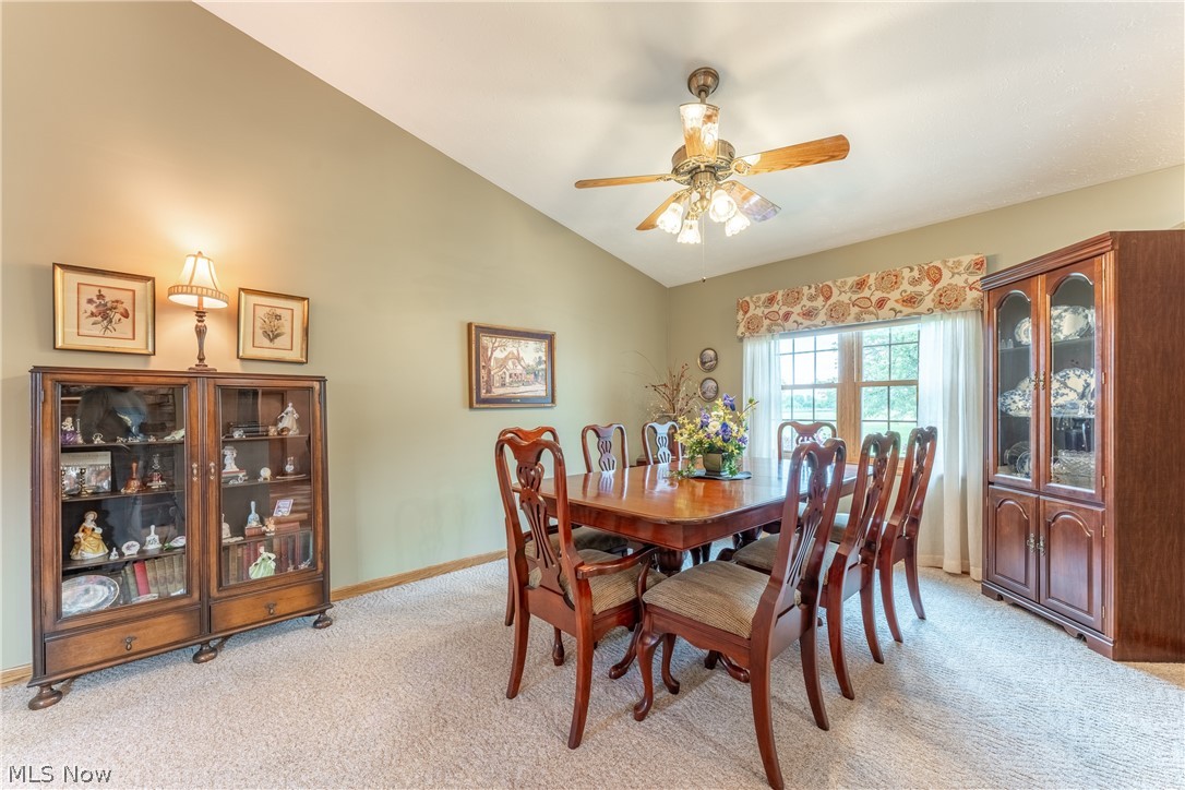 6341 Burbank Road Wooster, OH 44691 - Photo 10 of 36 Dining area featuring ceiling fan, vaulted ceiling, and light carpet