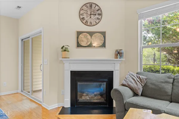 a living room with furniture a window and a fireplace