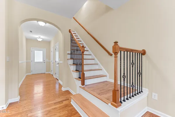 a view of entryway and hall with wooden floor