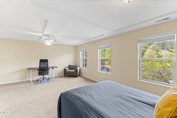 a bed room with a bed and a chair