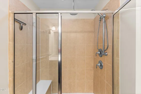 a bathroom with a glass shower door