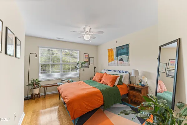 a bedroom with furniture and a large window