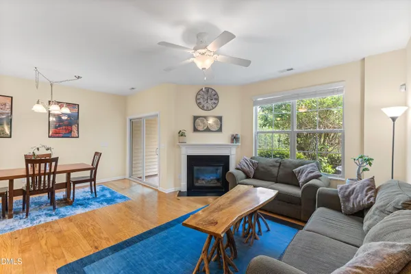 a living room with furniture a fireplace and a table
